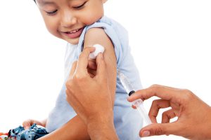 Little child have a vaccination shot in studio